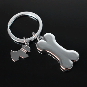 Polished silver metal dog and bone pendants on a stainless steel keychain