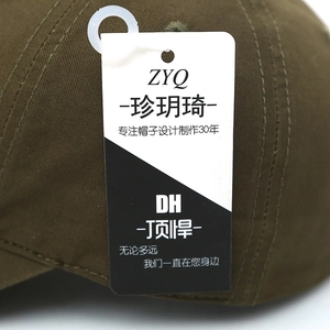 Close-up of olive green cotton baseball cap showing quality stitching and brand tag