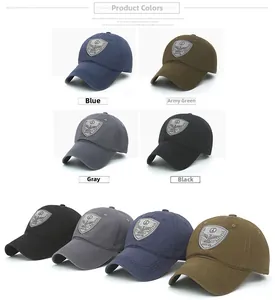 Detailed view of cotton baseball caps in blue, green, grey, and black with shield badges