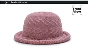 Front detail of pink knitted bucket hat with textured wavy weave pattern and rolled brim
