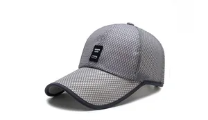 Macro detail of the grey mesh baseball cap showing breathable texture and logo patch