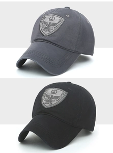 Detail view of cotton baseball caps with vintage eagle shield embroidery and stitching