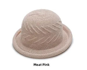 Close-up of nude pink woven knit bucket hat showing spiral texture and rolled edge