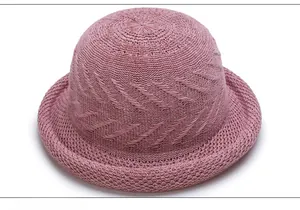 Detail of breathable hollow knit sun hat with wavy textured patterns in dusty pink