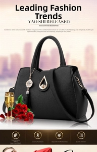 Detailed view of black lychee texture PU leather bag with golden teardrop clasp and tassel