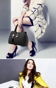 Detail of black lychee grain leather tote bag with gold teardrop lock and tassel charm
