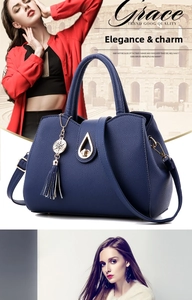 Close-up of dark blue lychee leather handbag featuring a metal twist lock and long tassels