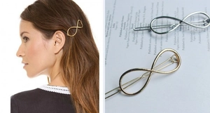 Detail view of gold and silver infinity shaped metal hair clips on model and magazine