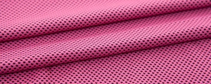 Close-up of pink cooling towel with breathable honeycomb mesh texture and dry-fit fabric