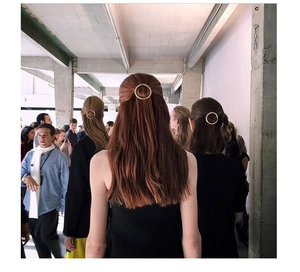 Minimalist circular gold hair clip shown on various hair colors for a versatile look