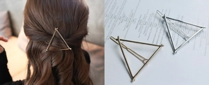 Detail of geometric triangle metal hair clips in gold and silver finish for women