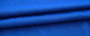 Macro shot of breathable blue mesh fabric showing porous cooling towel texture