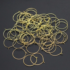 Bulk pack of golden circular earring hoops and wine glass ring charms for DIY jewelry making