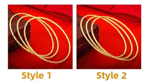 Detail of gold plated bangle set showing matte engraved and spiral twisted designs