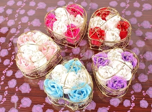 Top view of five heart-shaped wire baskets with colorful soap roses for Valentine gifts