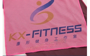 Macro shot of pink cooling towel mesh fabric with custom KX-FITNESS logo print