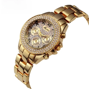 Detail of luxury gold alloy watch featuring crystal encrusted bezel and Roman numerals