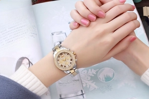 Detailed view of luxury two-tone women watch featuring diamond-encrusted bezel and classic dial