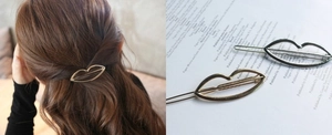 Lip-shaped metal hair clips in gold and silver finish shown on a model and as still life
