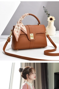 Brown lychee leather handbag with golden twist lock and houndstooth scarf on handle