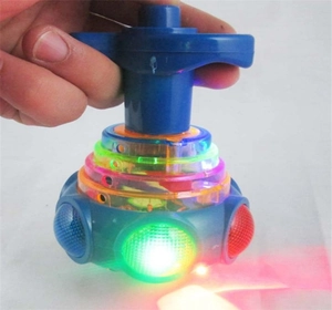 Close-up of a blue glowing spinning top toy for kids with colorful LED lights in action