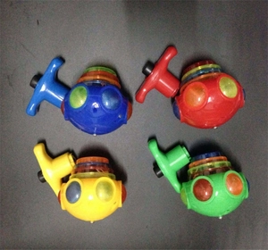 Top view of four colorful light-up music spinning tops in blue red yellow and green