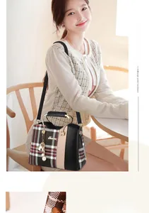 Close-up of the elegant plaid fabric and black leather mix with a gold metal handle