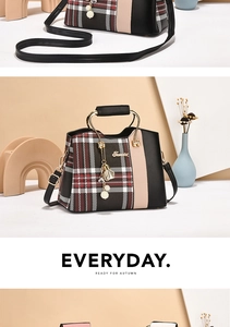 Detail of minimalist plaid crossbody bag featuring metal handle and decorative tassel