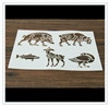 Detail view of five brown animal stencil patterns including deer and bird on wood