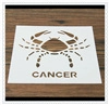 Detail of white hollow-out stencil with crab design and Cancer zodiac text for latte art