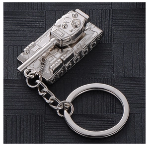 Detailed macro view of a silver metal tank keychain model on a textured black background