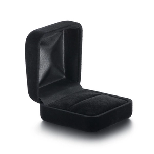 Detailed view of an open black velvet ring box showing the soft interior lining