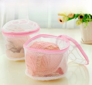 Close-up of cylindrical mesh laundry bag with pink zipper for delicate bra protection