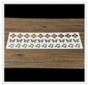 Macro detail of white coffee stencils with hollow cross, butterfly, and music note patterns