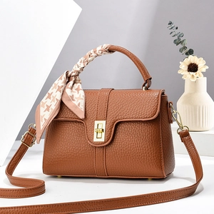 Brown litchi grain leather handbag with gold twist lock and houndstooth silk scarf handle