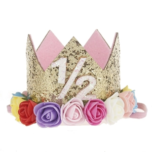 Detail of baby gold glitter crown with multi-colored foam roses and 1/2 birthday digit