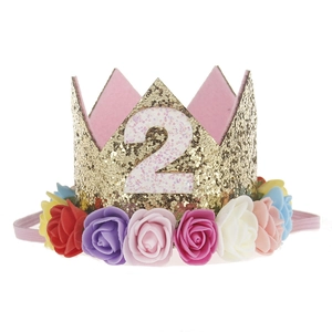 Detail of gold glitter birthday crown with colorful roses and white number 2 for kids