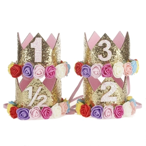 Set of four gold glitter baby crown headbands with colorful floral accents and age numbers