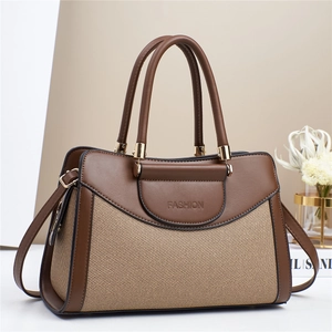 Women's pillow handbag with contrast brown leather and woven texture, crossbody style
