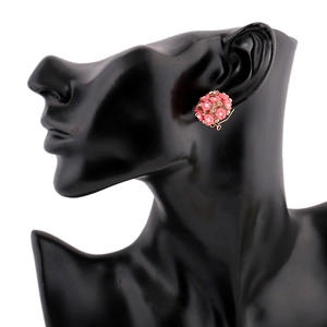Detail of pink floral stud earrings with rhinestones on a black mannequin