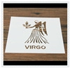 Detail of Christmas coffee stencil with Virgo constellation pattern on wooden surface