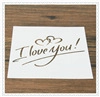 Macro detail of Christmas coffee stencil with heart patterns and I Love You script text
