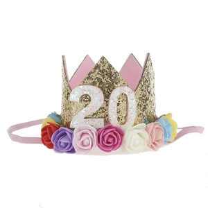 Detail of colorful artificial roses and gold sequin crown headpiece for age 20 birthday
