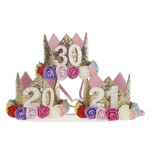 Detail of glitter gold crown headbands with colorful roses and numbers for birthdays