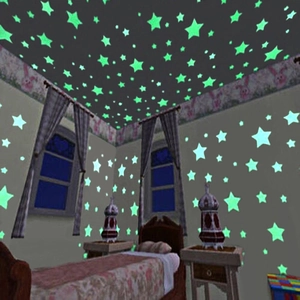 Luminous star wall stickers in dark room showing glowing green ceiling decor effect