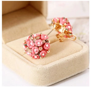 Detail of pink floral cluster clip-on earrings with white stamens and gold accents