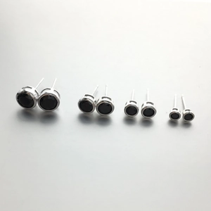 Set of four pairs of round black zircon stud earrings in silver bezel settings