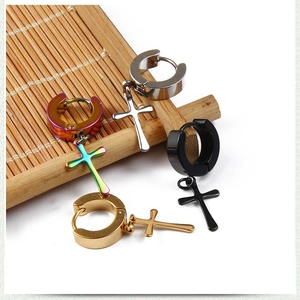Detail of cross pendant earrings in gold, black, silver and multi-color stainless steel