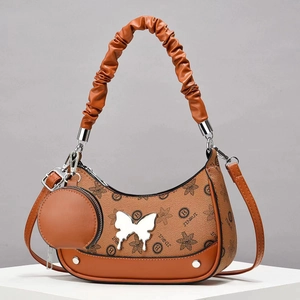 Brown leather crossbody hobo bag with floral patterns and silver butterfly metal detail