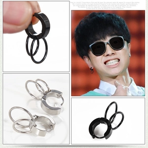 Macro detail of men's titanium steel triple hoop earrings in black and silver finish